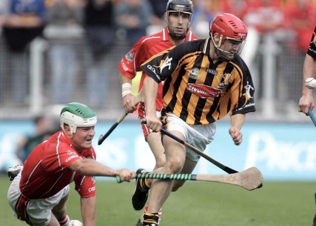 Kilkenny's Tommy Walsh breaks away from the attention of Cork's Niall McCarthy