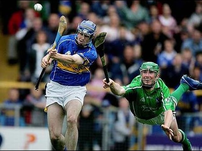 Seamus Hickey (r) tries to stop Seamus Butler from scoring Tipperary's opening goal