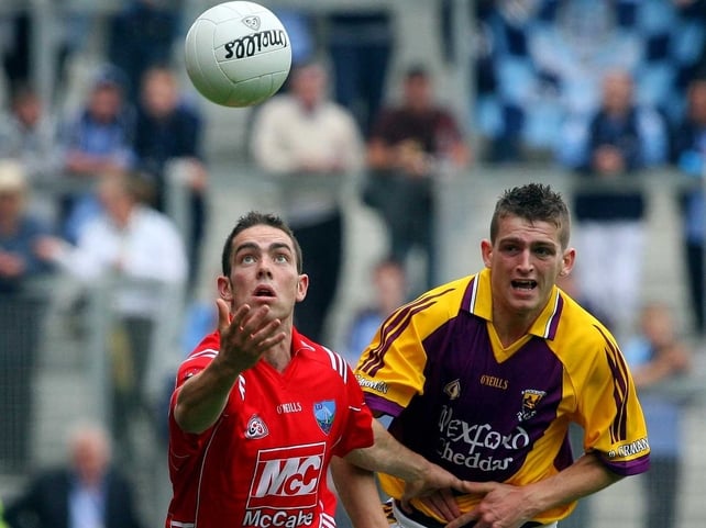 Louth's John O'Brien (left) and Wexford's Adrian Flynn chase the ball