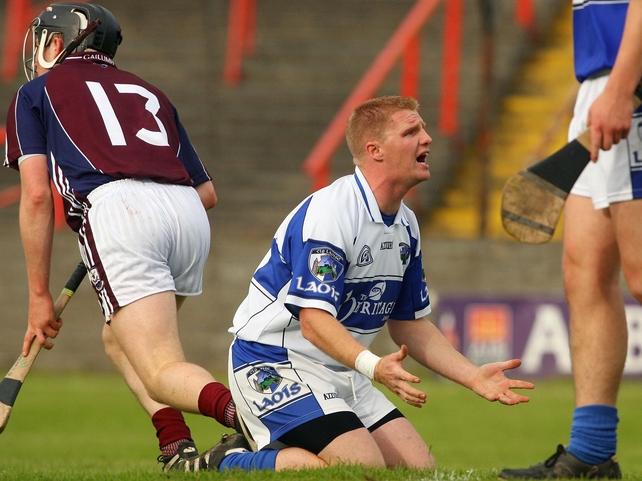 Laois goalkeeper Patrick Mullaney looks to his team-mates as Niall Healy of Galway scores a goal