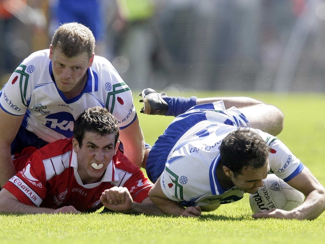 James McMahon of Tyrone grapples with Eoin Lennon and Paul Finlay of Monaghan