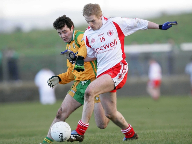 Tyrone's Sean O'Neill & Niall McCready of Donegal tussle for possesion