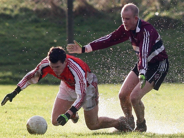 Armagh's Paul McGaughey & Martin Murray of St Mary's try to deal with the difficult underfoot conditions