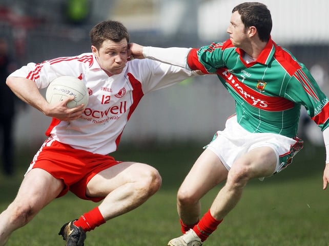 Enda McGinley tries to evade Mayo's Keith Higgins in Omagh this afternoon