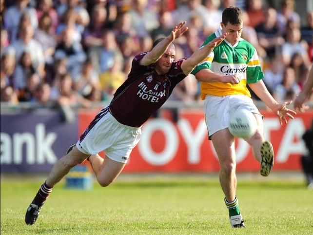 Offaly's Niall McNamee is challenged by John Smyth