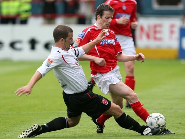 Shelbourne's James Keddy is tackled by John Flanagan of Dundalk
