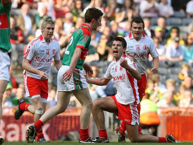 Tyrone's Ciaran Girvan celebrates a point with Mayo's David Dolan looking on