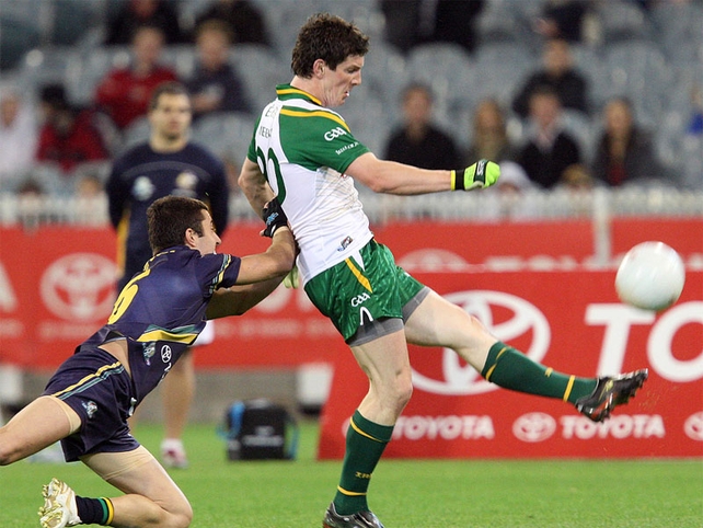 Michael Meehan evades the challenge of Kade Simpson