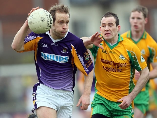 Brian Kavanagh of Crokes is harried by Corofin's Damien Burke