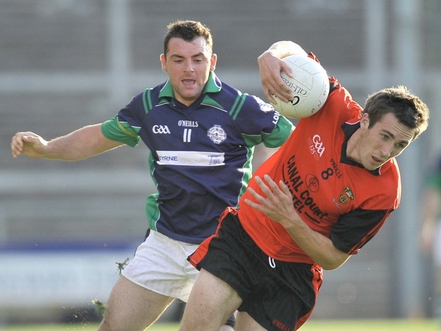 Down's Dan Gordon struggles to keep his balance as Padraig Duffy of London closes in
