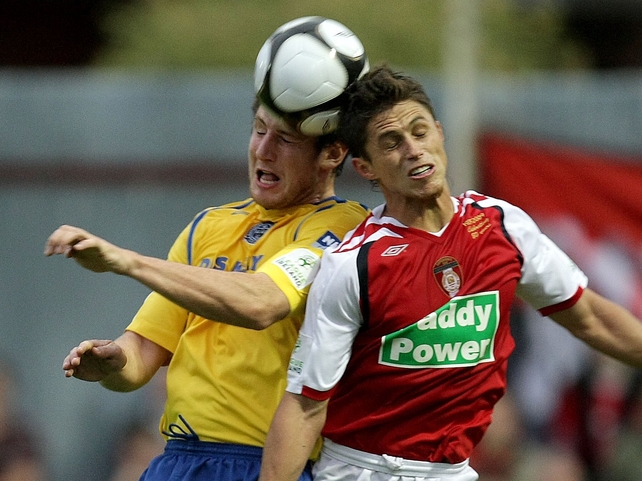 Ryan Guy and Ken Oman (left) compete for the ball