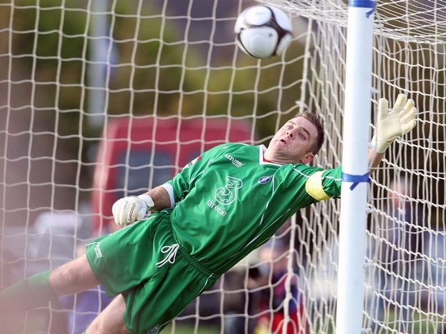 Waterford 'keeper Michael Devine is helpless as Brennan's eighth-minute free-kick flies into the top corner