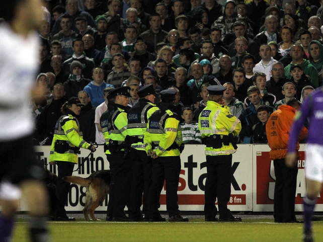 Gardaí confronted fans as they threw bottles and wood onto the pitch