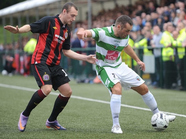 Mark Quigley of Bohemians fights to get the ball as Danny Holmes of TNS shields it