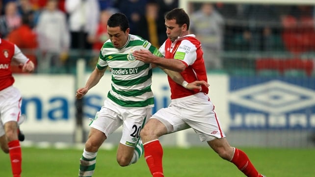 Dave Mulchay of St Pat's Athletic and Billy Dennehy of Shamrock Rovers battle for possession at Richmond Park