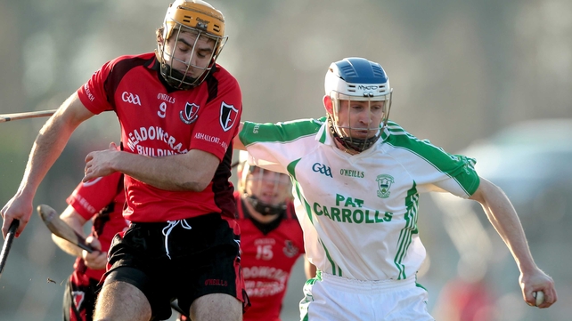 Oulart-the-Ballagh's David Redmond O'Loughlin Gaels' battle for possession at Dr Cullen Park
