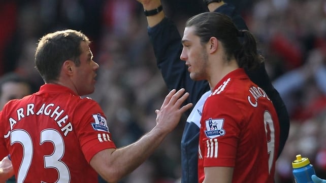 Andy Carroll (r) gets some advice from Jamie Carragher as he comes on for his first Liverpool appearance