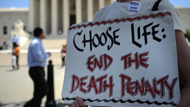 US - An anti-death penalty activist passes out pamphlets during a rally outside the US Supreme Court in 2009 US - An anti-death penalty activist passes out pamphlets during a rally outside the US Supreme Court in 2009