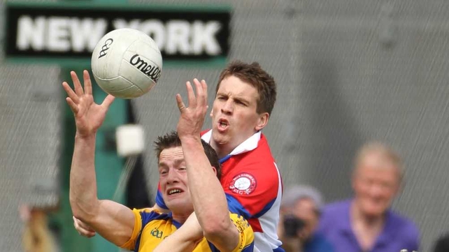 Kevin Higgins, goalscorer for Roscommon, clashes with Stephen Harold of New York