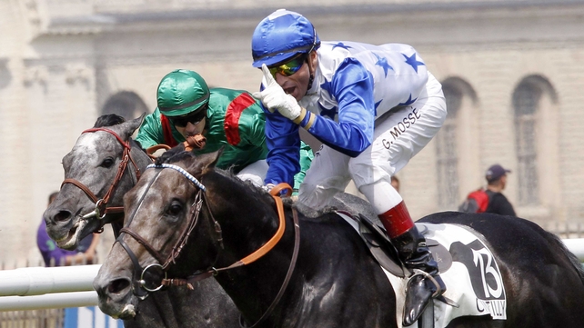 French jockey Gerald Mosse celebrates - as he rides his foal Reliable Man - after winning the 171st Prix du Jockey Club, also known as the French Derby