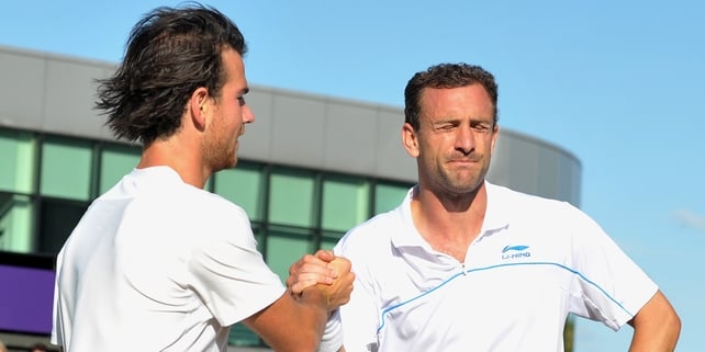 A dejected Conor Niland congratulates Adrian Mannarino at SW19