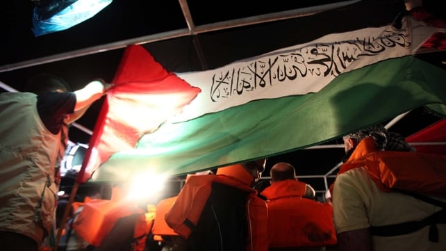 Mavi Marmara - Turkish human-rights activist hold a Palestinian flag hours before the Israeli Navy attack Mavi Marmara - Turkish human-rights activist hold a Palestinian flag hours before the Israeli Navy attack