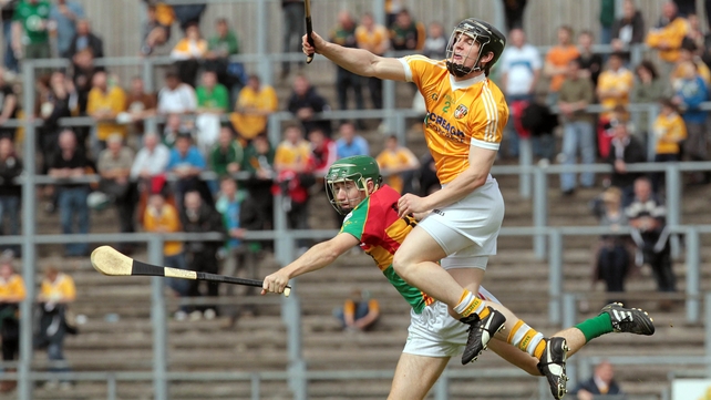 Antrim victory - Chris McGuinness out-jumps Carlow's Daryl Roberts as the Saffrons took the spoils at Casement Park