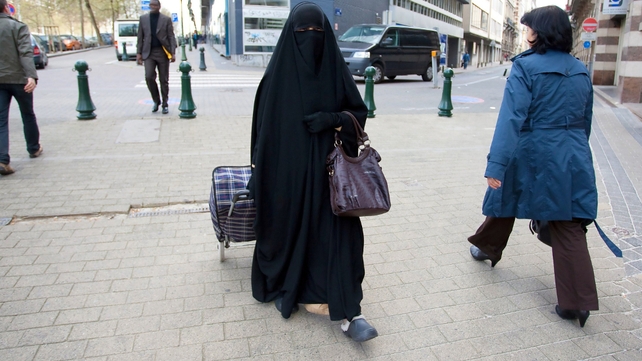 Belgium - A Muslim woman dressed in niqab walks through Brussels Belgium - A Muslim woman dressed in niqab walks through Brussels