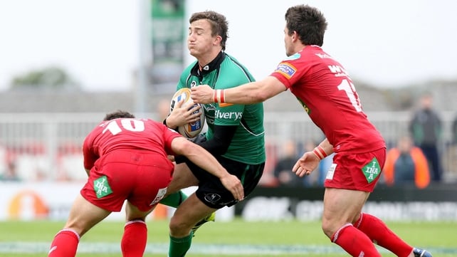 Matthew Jarvis of Connacht is double tackled by Dan Newton and Liam Williams of Scarlets