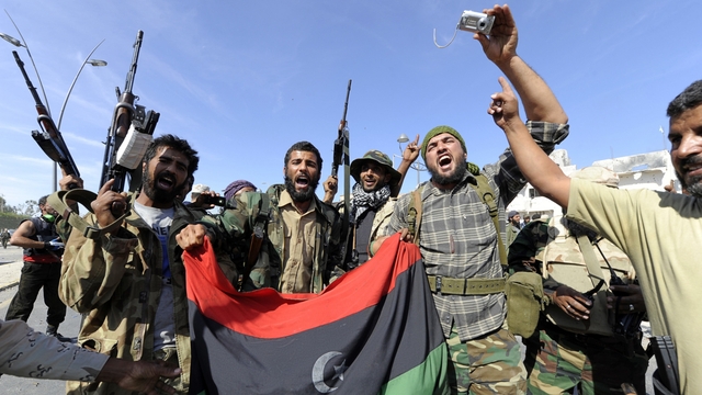 NTC soldiers celebrate the demise of the former LIbyan leader