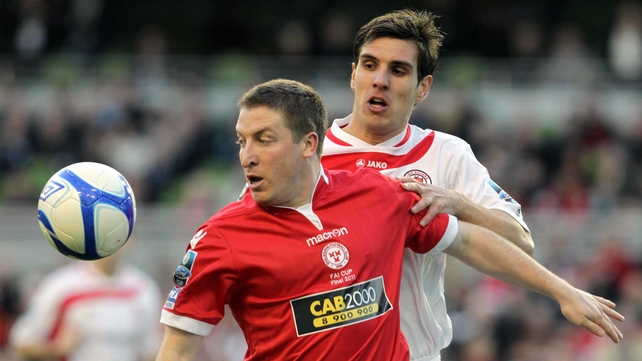Shelbourne's Philly Hughes (red) is marked by Gavin Peers (white)