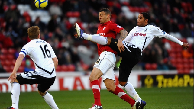Ashley Williams (R) of Swansea battles with Craig Davies of Barnsley