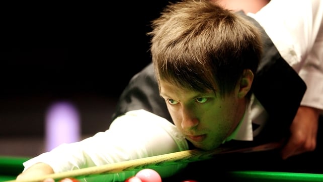 Judd Trump has recovered from a bout of food poisoning but is losing his second round tie with Ali Carter 5-3