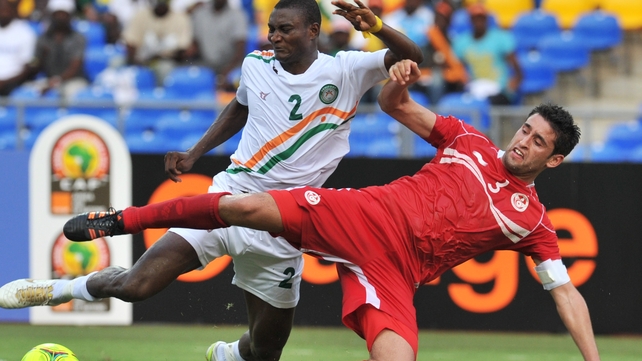 Niger's Moussa Maazou Ouwo (left) vies with Tunisia's Karim Haggui