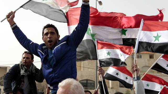 A Syrian living in Jordan waves his national flag as he takes part in a demonstration in support of Syrian President Bashar al-Assad outside the Syrian embassy in Amman A Syrian living in Jordan waves his national flag as he takes part in a demonstration in support of Syrian President Bashar al-Assad outside the Syrian embassy in Amman