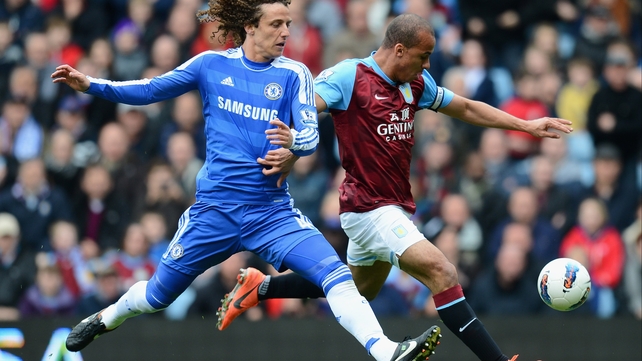 Gabriel Agbonlahor gets a shot away despite the attentions of David Luiz