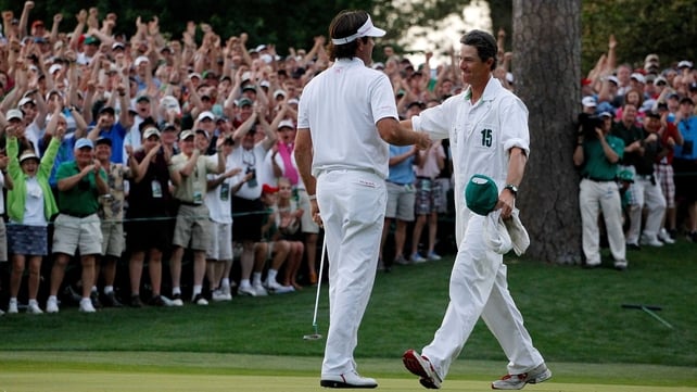 Bubba Watson celebrates with his caddie following his play-off victory at the 10th hole