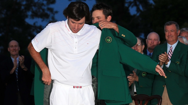 2012 Masters champion Charl Schwartzel presents Bubba Watson with his Green Jacket