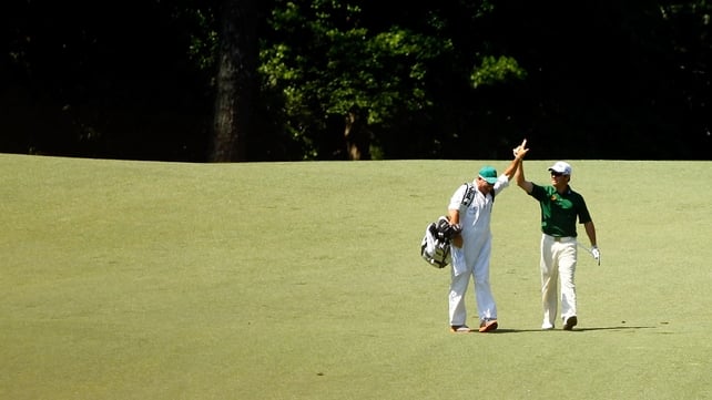 Louis Oostehuizen high fives after holing out from 235 yards on the second hole