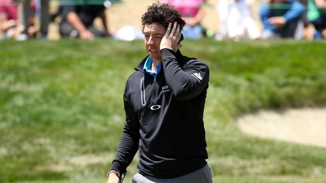 Rory McIlroy reacts after making a mess of the final hole