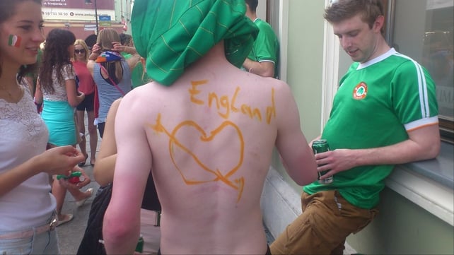 An Ireland fan trusts another fan to write 'Trap's Army' on his back. Sent by an RTÉ.ie user called James
