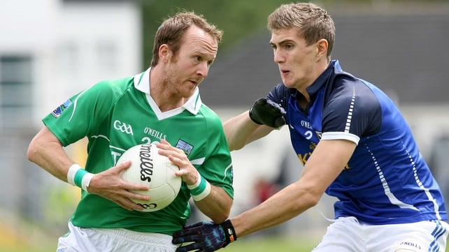 Paul Ward of Fermanagh holds off Cavan's Killian Clarke