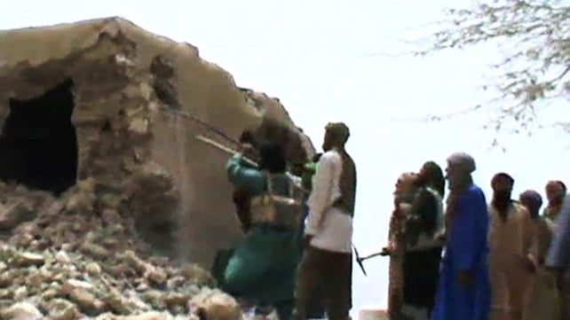 A still from a video showing the destruction of an ancient shrine in Timbuktu A still from a video showing the destruction of an ancient shrine in Timbuktu
