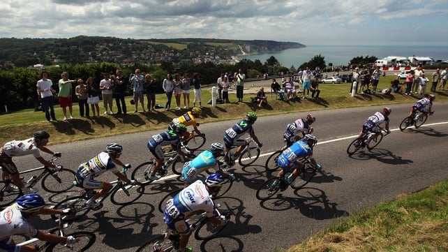 The peleton take the coast road earlier today