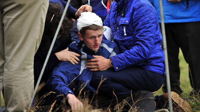 Jason Blue receives attention after he was struck by Rory McIliroy's ball yesterday