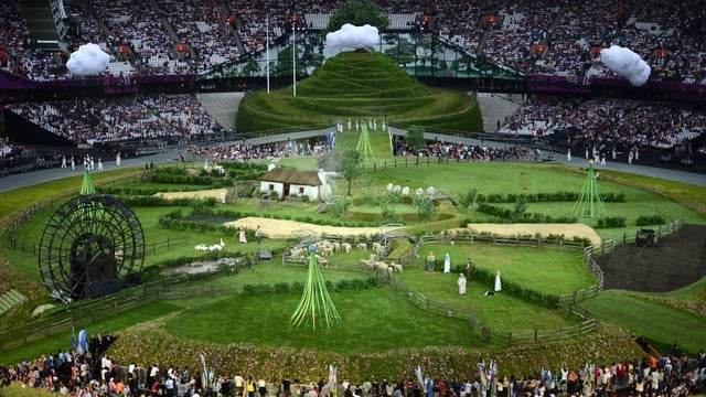 Animals and actors enter the stadium for the British meadow scene