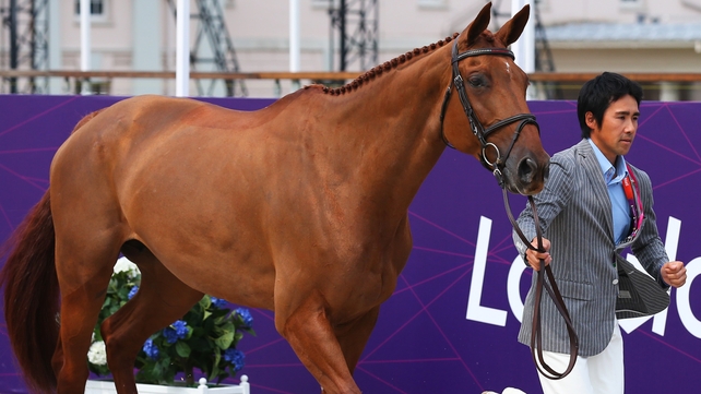 Japan's Yoshiaki Oiwa, riding Noonday de Conde, leads after the dressage