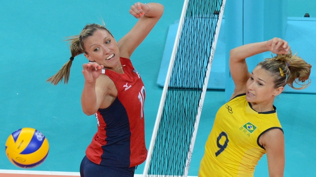 Brazil's Fernanda Ferreira (R) spikes the ball as US player Jordan Larson attempts to block in tonight's pool match