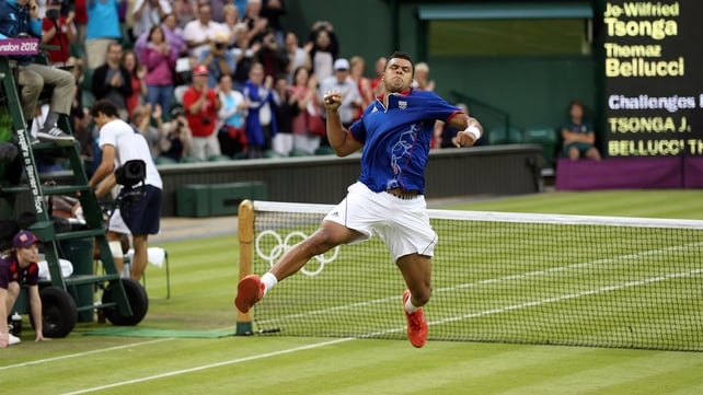 An ebullient Jo-Wilfried Tsonga celebrates finally crossing the finish line in his clash with Milos Raonic