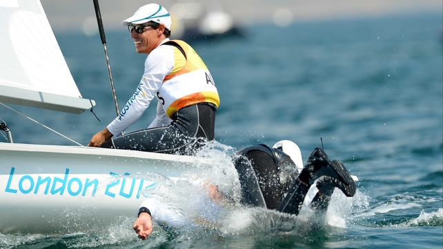 Malcolm Page (R) leaps off the boat as teammate Mathew Belcher (L) sails on